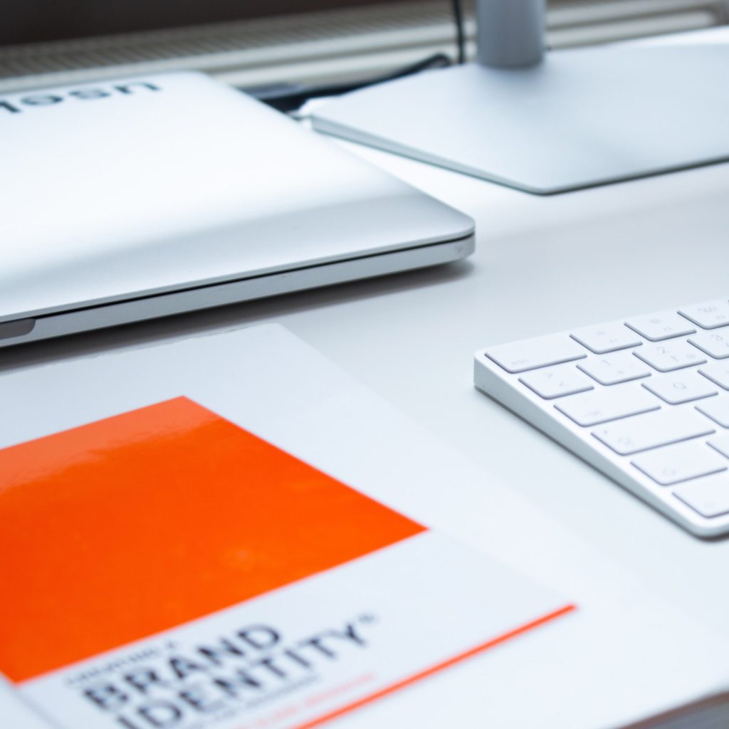 An office set up with a book explaining brand identity. 